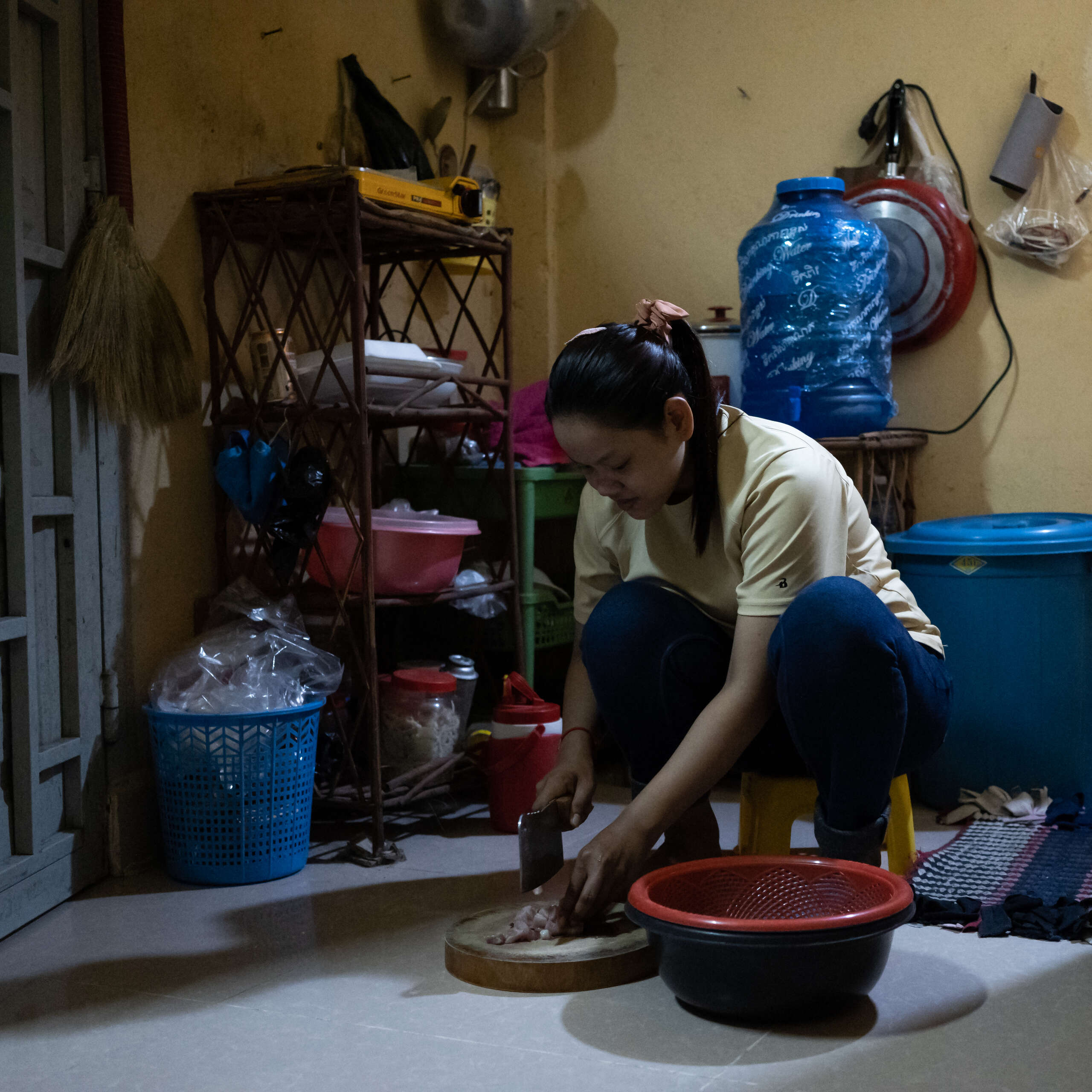 Garment worker at home preparing a meal.
